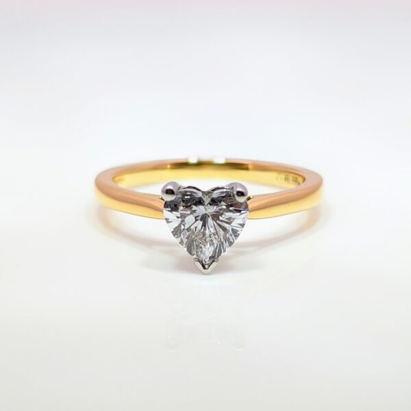 This romantic Heart Shaped Lab Grown Diamond is set in an 18ct yellow gold and platinum band. With a D Colour and VS1 Clarity you'll have hearts beating when they see it. Perfect for Valentine's and special occasions. IGI Certificated.