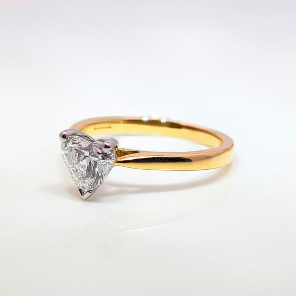 This romantic Heart Shaped Lab Grown Diamond is set in an 18ct yellow gold and platinum band. With a D Colour and VS1 Clarity you'll have hearts beating when they see it. Perfect for Valentine's and special occasions. IGI Certificated.