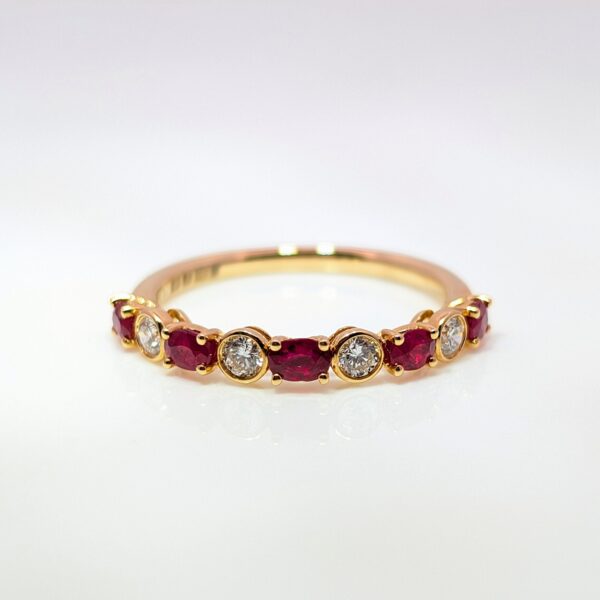 This stunning half eternity ring features a 5 vibrant oval rubies and 4 round sparkling diamonds, set in a luxurious 18ct yellow gold band. Ruby jewellery is a timeless gift, but is especially meaningful to those with a July birthday.