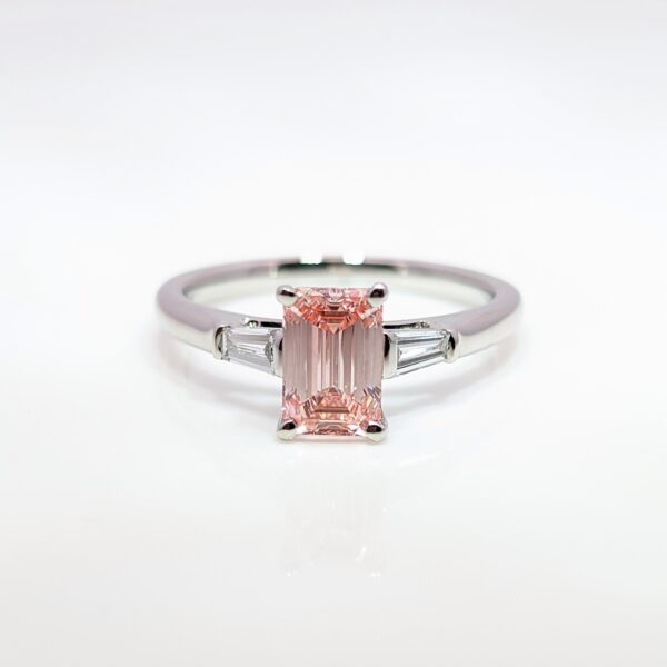 Discover our bespoke coloured lab grown diamond range. This pink diamond is set in a platinum mount with white diamond shoulders.