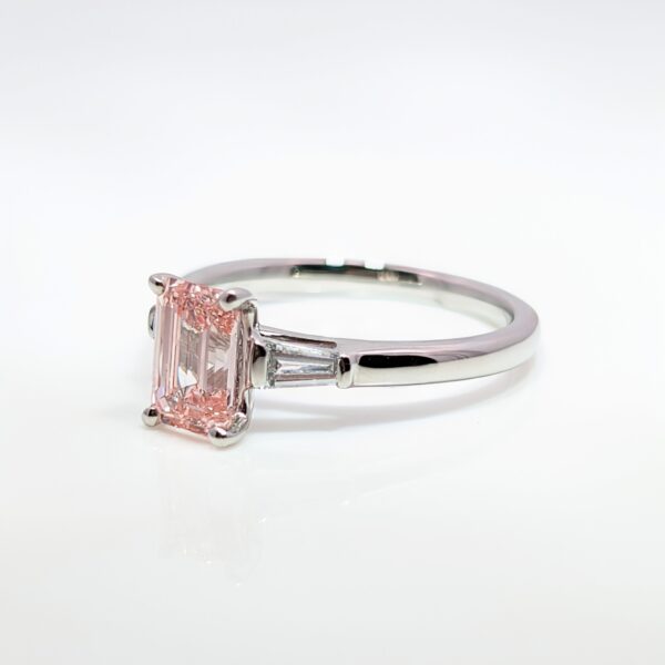 Discover our bespoke coloured lab grown diamond range. This pink diamond is set in a platinum mount with white diamond shoulders.