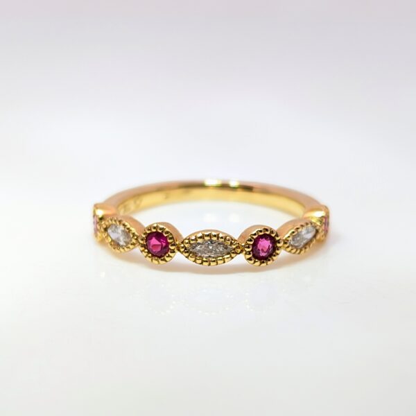 This elegant diamond and ruby band is stunning, featuring a motif of alternating round and marquise shapes and dainty milgrain detailing in 18ct yellow gold. Ruby jewellery is a timeless gift, but is especially meaningful to those with a July birthday.