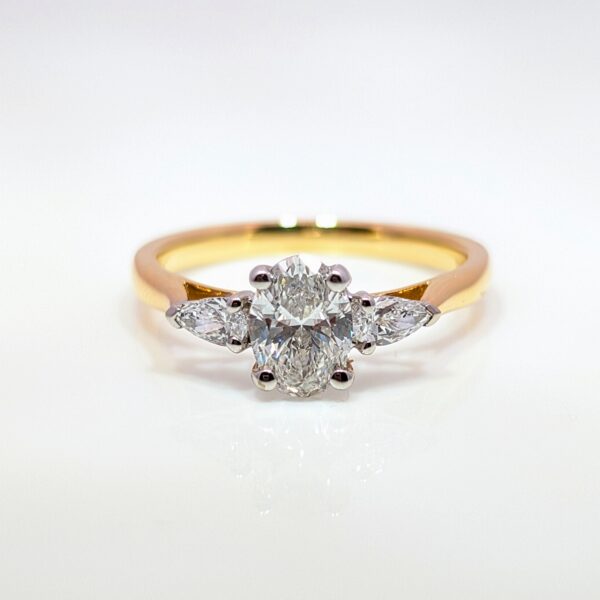 Discover our Oval Cut Lab Diamond Trilogy Ring, featuring a 0.75ct brilliant D/VS1 centre lab-grown diamond and a 0.21ct shoulder stones, set in luxurious 18ct yellow gold band. Celebrating the ‘past, present, and future’ symbolism, this piece makes an exceptional engagement ring or something to celebrate a special occasion.