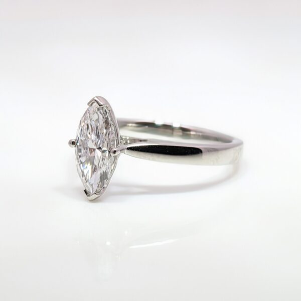 Discover the timeless beauty of this lab grown marquise diamond ring, making it an ethical and sustainable choice for your engagement ring. The stunning diamond is elegantly set in a platinum band.